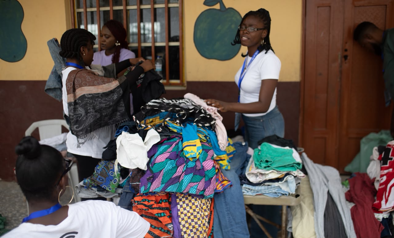 Volunteers organizing donated clothing at the Awoyaya community outreach