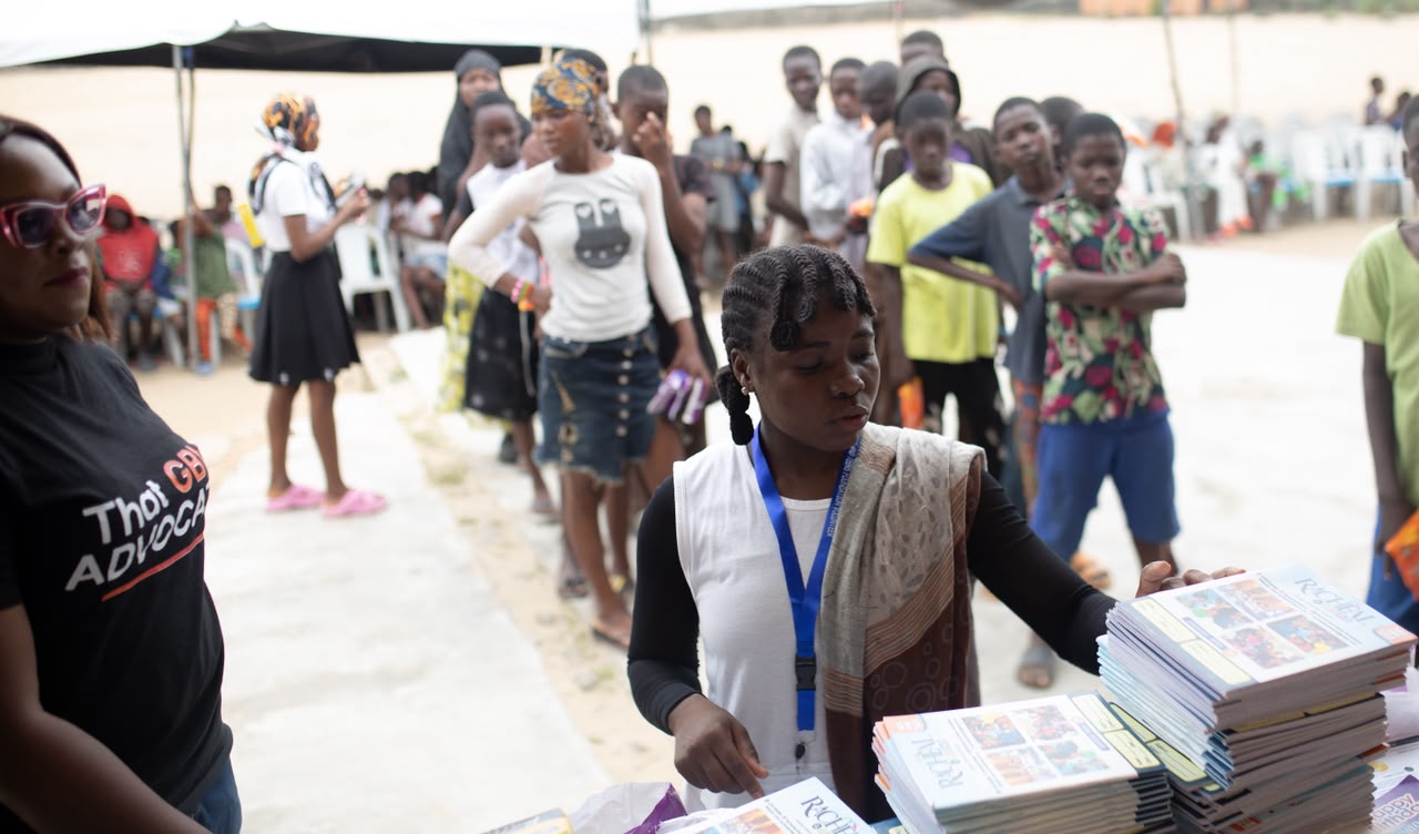 Volunteers preparing educational materials for teenagers at the Awoyaya outreach