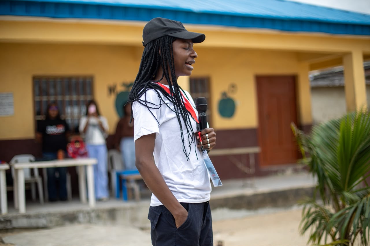 A guest speaker addressing teenagers during the Awoyaya community outreach